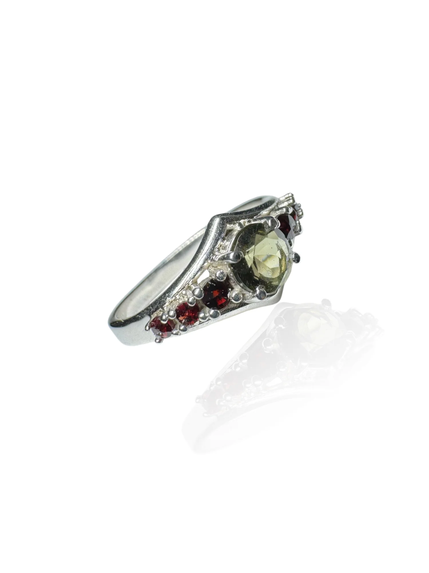 Moldavite ring round with garnets