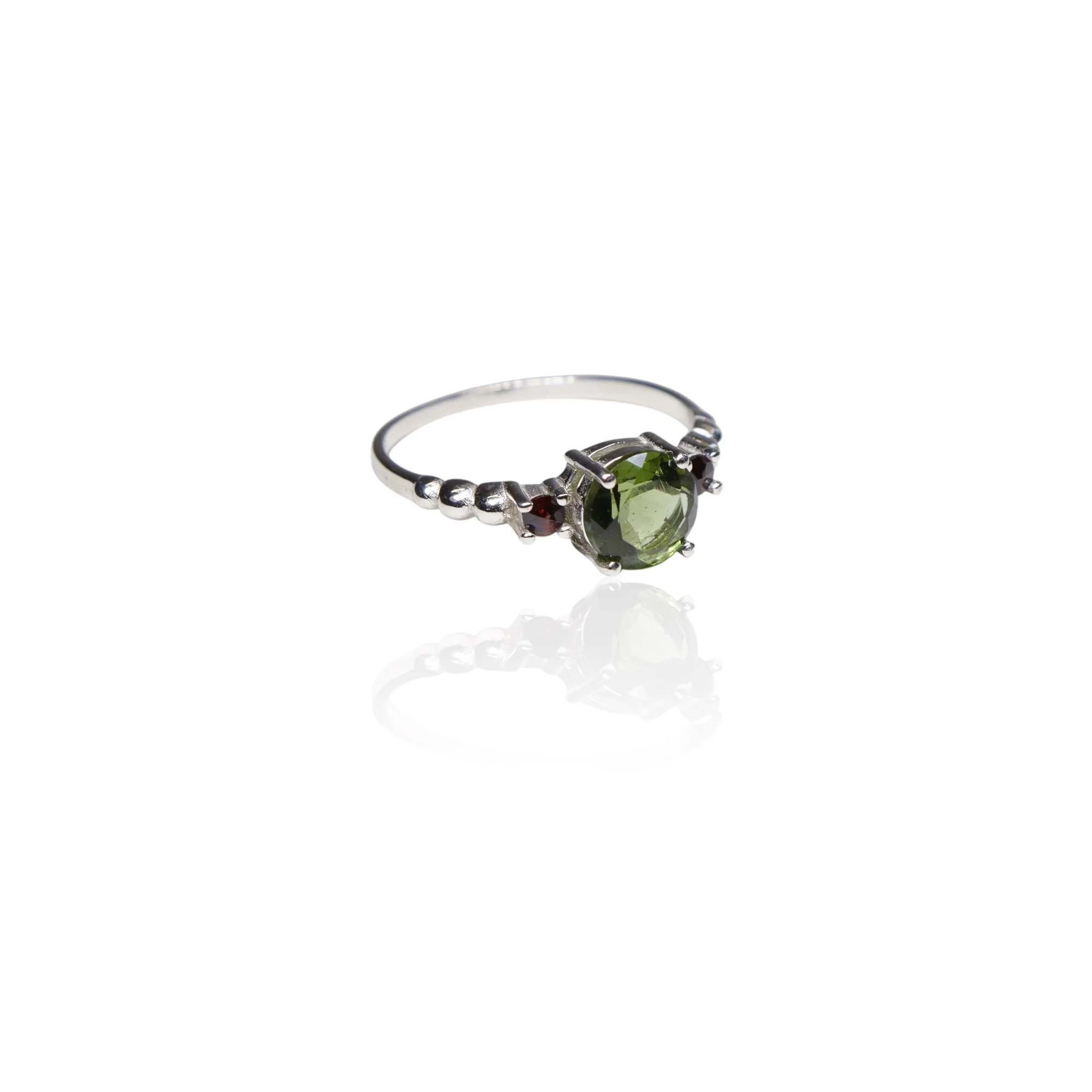 Moldavite ring round with garnets